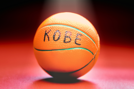Basketball with KOBE written on it.
