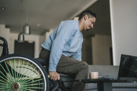 Man trying to get out of his wheelchair