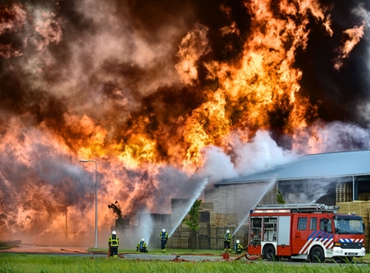 firefighters fighting fire in industrial area
